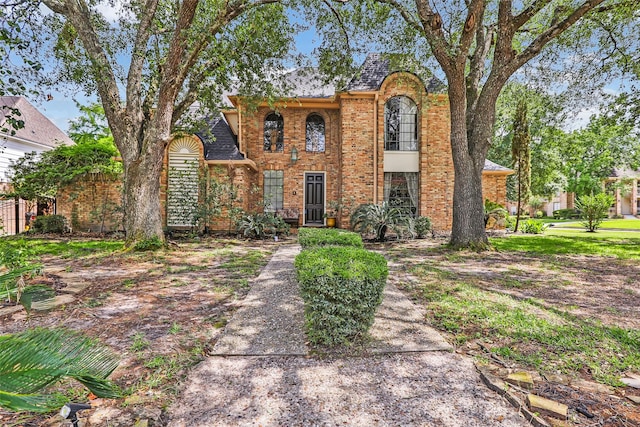 6319 Wimbledon Villas Dr, Spring, TX 77379 - traditional-style house featuring brick siding and a shingled roof