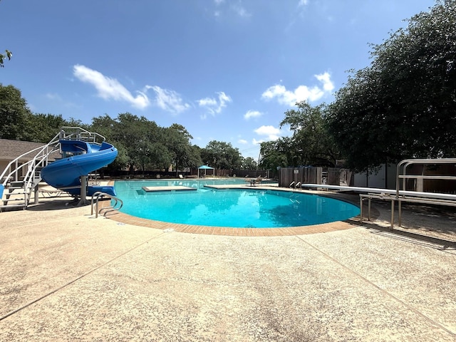 11414 Cedar Creek Dr, Houston, TX 77077 - view of pool with a patio, a water slide, a diving board, and fence