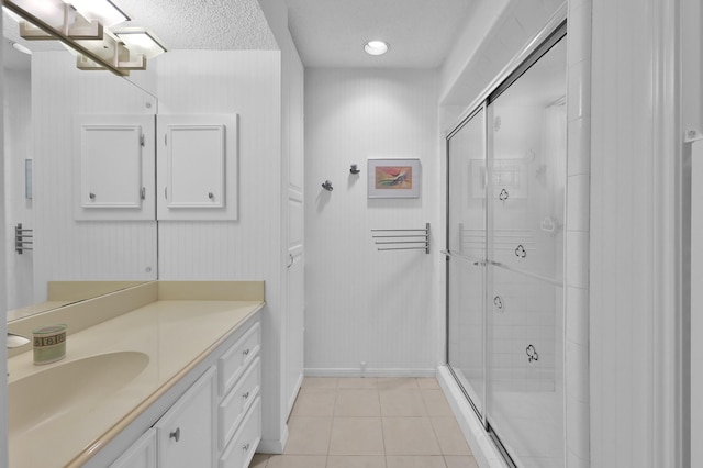 11414 Cedar Creek Dr, Houston, TX 77077 - bathroom with baseboards, tile patterned floors, a shower stall, vanity, and recessed lighting