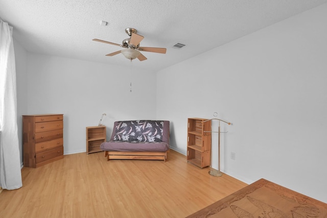 11414 Cedar Creek Dr, Houston, TX 77077 - living area with wood finished floors, a ceiling fan, a textured ceiling, and baseboards