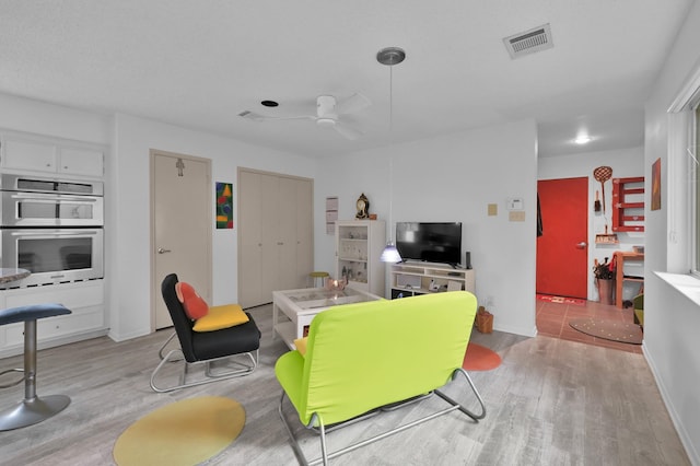 11414 Cedar Creek Dr, Houston, TX 77077 - living room featuring light wood-type flooring, ceiling fan, and baseboards
