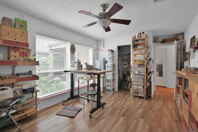 11414 Cedar Creek Dr, Houston, TX 77077 - exercise area featuring wood finished floors, ceiling fan, and a textured ceiling