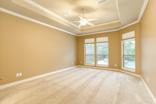 106 Arrowhead Dr, Lake Jackson, TX 77566 - carpeted spare room featuring a tray ceiling, ornamental molding, a ceiling fan, and baseboards