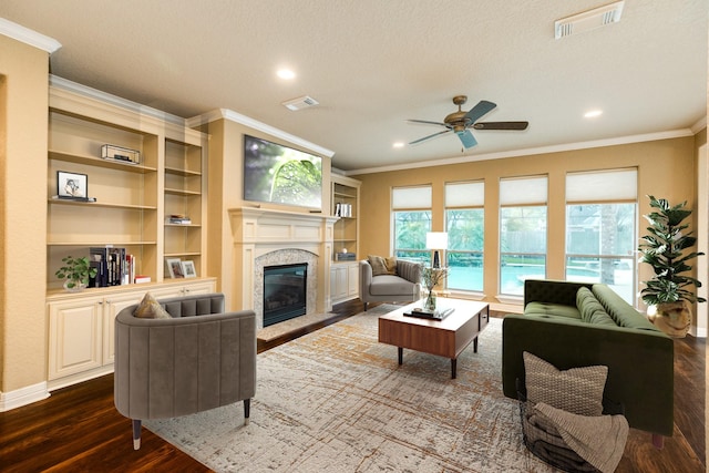 106 Arrowhead Dr, Lake Jackson, TX 77566 - living room with crown molding, dark wood-type flooring, a high end fireplace, a ceiling fan, and recessed lighting