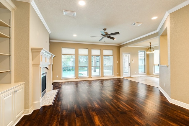 106 Arrowhead Dr, Lake Jackson, TX 77566 - unfurnished living room featuring a high end fireplace, ceiling fan, ornamental molding, wood-type flooring, and a chandelier