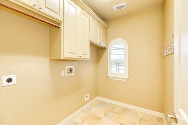 106 Arrowhead Dr, Lake Jackson, TX 77566 - clothes washing area featuring hookup for an electric dryer, cabinet space, washer hookup, and baseboards