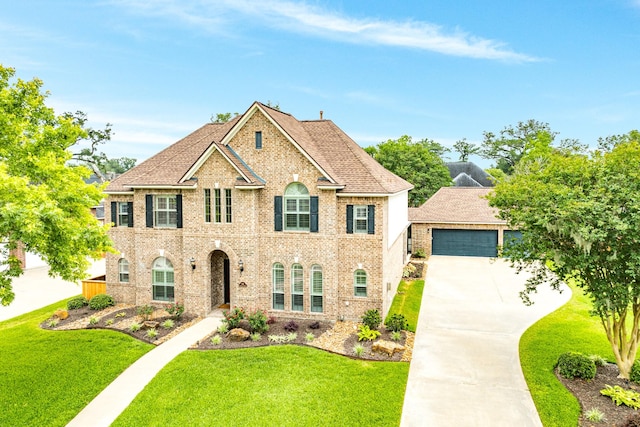 106 Arrowhead Dr, Lake Jackson, TX 77566 - georgian-style home with a front yard, brick siding, a garage, and concrete driveway
