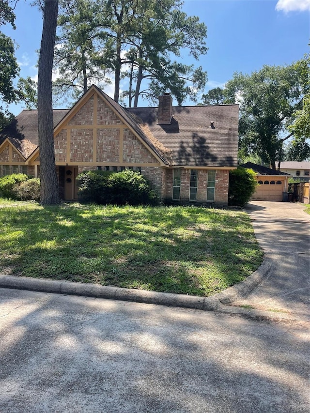 5727 Pebble Springs Dr, Houston, TX 77066 - view of front of property featuring a front yard, an attached garage, a chimney, concrete driveway, and brick siding