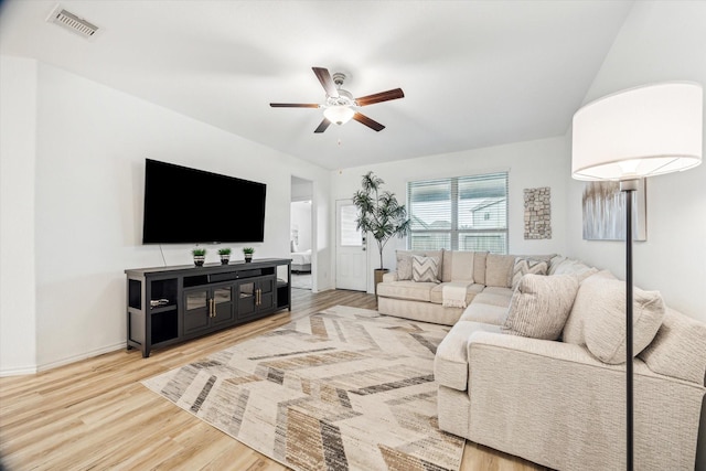 living room with ceiling fan, light wood-style flooring, and baseboards