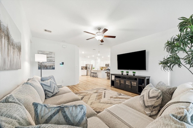 living room featuring ceiling fan and wood finished floors