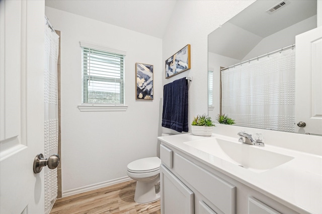 full bath featuring lofted ceiling, wood finished floors, toilet, vanity, and baseboards