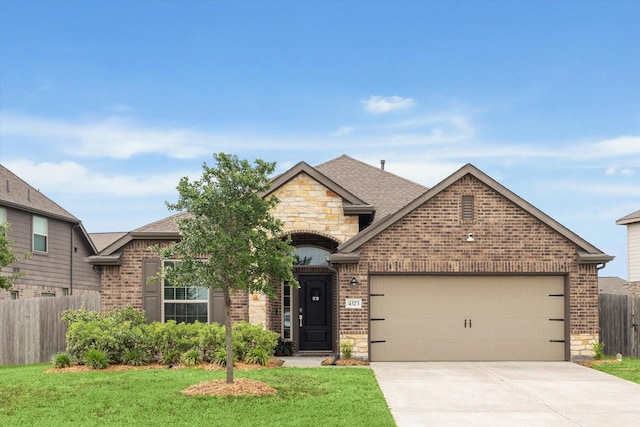 french country inspired facade with brick siding, stone siding, an attached garage, driveway, and roof with shingles