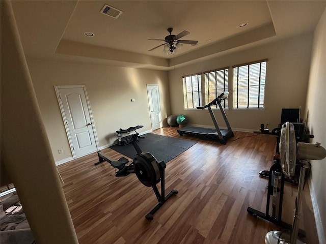 24211 Bella Florence Dr, Richmond, TX 77406 - workout area with a tray ceiling, wood finished floors, ceiling fan, and recessed lighting