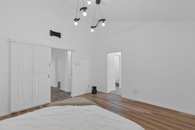 10731 Sageberry Dr, Houston, TX 77089 - bedroom featuring a high ceiling, wood finished floors, baseboards, and a closet