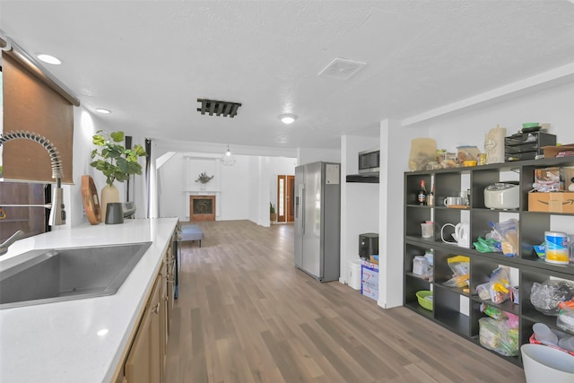 10731 Sageberry Dr, Houston, TX 77089 - kitchen featuring appliances with stainless steel finishes, a sink, wood finished floors, and light countertops