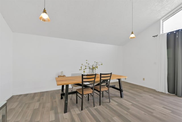 10731 Sageberry Dr, Houston, TX 77089 - dining space with wood finished floors, vaulted ceiling, and baseboards