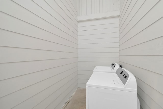 10731 Sageberry Dr, Houston, TX 77089 - laundry room featuring independent washer and dryer and wood walls