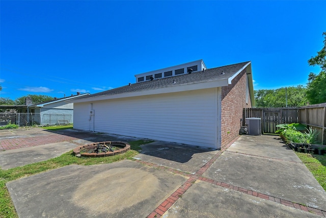 10731 Sageberry Dr, Houston, TX 77089 - view of home's exterior with brick siding, fence, central air condition unit, a patio, and a gate