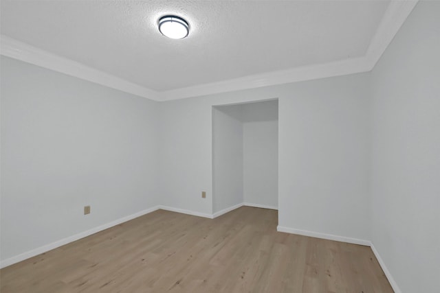 10731 Sageberry Dr, Houston, TX 77089 - spare room featuring light wood-style flooring, baseboards, and a textured ceiling