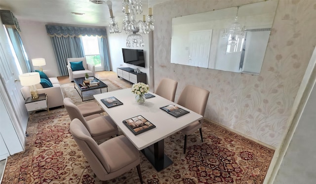 dining room featuring wallpapered walls and a chandelier