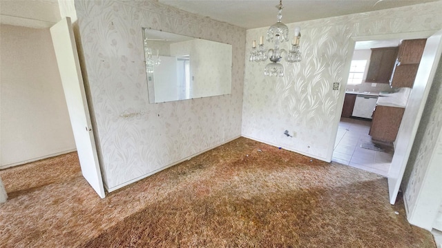 unfurnished dining area featuring carpet, a chandelier, and wallpapered walls