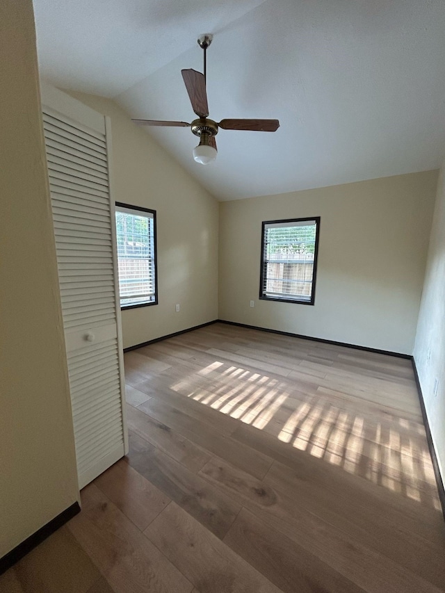 9974 Elder St, Willis, TX 77318 - unfurnished room with healthy amount of natural light, wood finished floors, lofted ceiling, ceiling fan, and baseboards