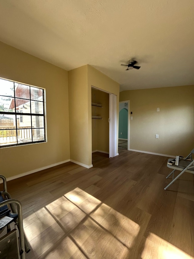9974 Elder St, Willis, TX 77318 - empty room with wood finished floors, baseboards, and a ceiling fan
