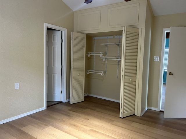 9974 Elder St, Willis, TX 77318 - unfurnished bedroom with a closet, light wood-style floors, and baseboards
