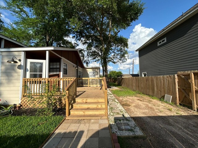 9974 Elder St, Willis, TX 77318 - view of home's exterior featuring fence and a deck