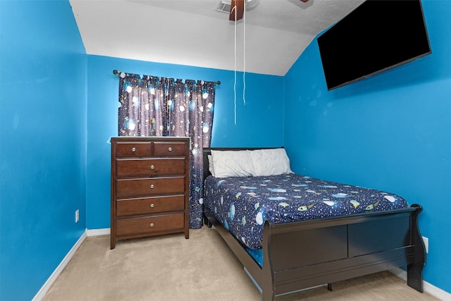 carpeted bedroom with baseboards, vaulted ceiling, and a ceiling fan