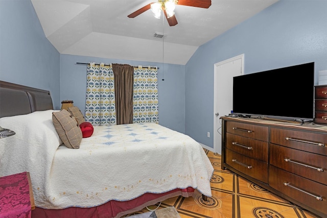 bedroom featuring lofted ceiling, light tile patterned floors, and ceiling fan
