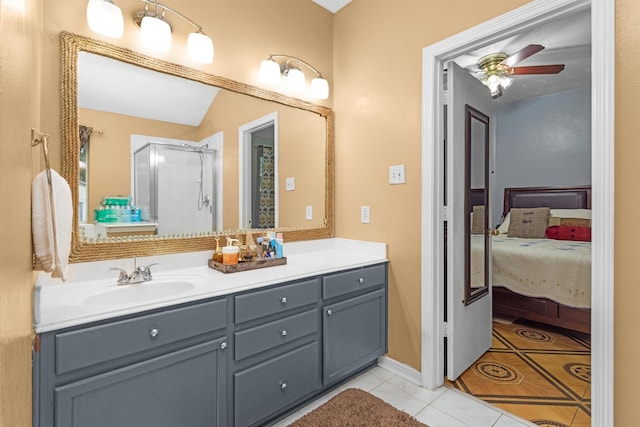 full bathroom with tile patterned flooring, a shower stall, ceiling fan, vanity, and ensuite bath