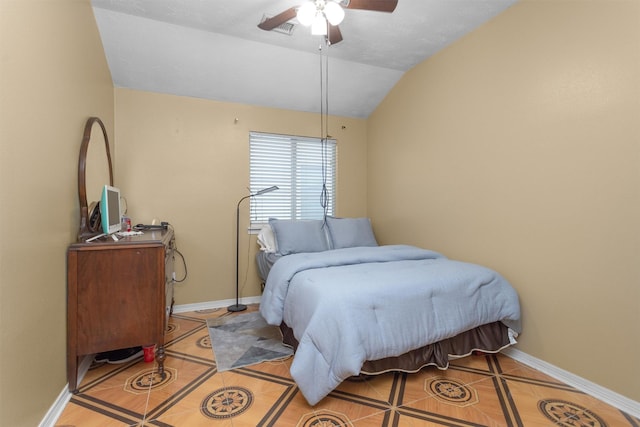 tiled bedroom with lofted ceiling, baseboards, and ceiling fan