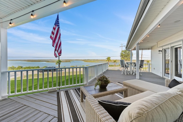 4321 Jolly Roger Rd, Galveston, TX 77554 - deck with a water view, outdoor dining area, and a lawn
