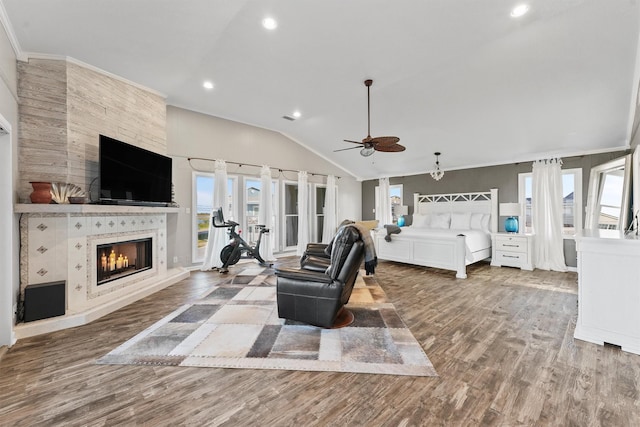 4321 Jolly Roger Rd, Galveston, TX 77554 - bedroom with lofted ceiling, a tile fireplace, wood finished floors, recessed lighting, and access to outside