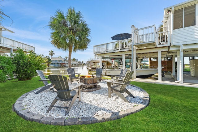 4321 Jolly Roger Rd, Galveston, TX 77554 - view of green lawn with a fire pit and a deck with water view
