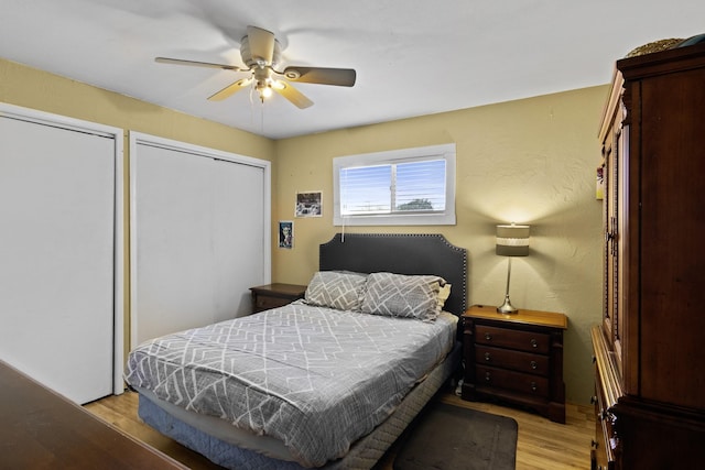 309 Kings Hl, Palacios, TX 77465 - bedroom featuring light wood-type flooring, a ceiling fan, and two closets
