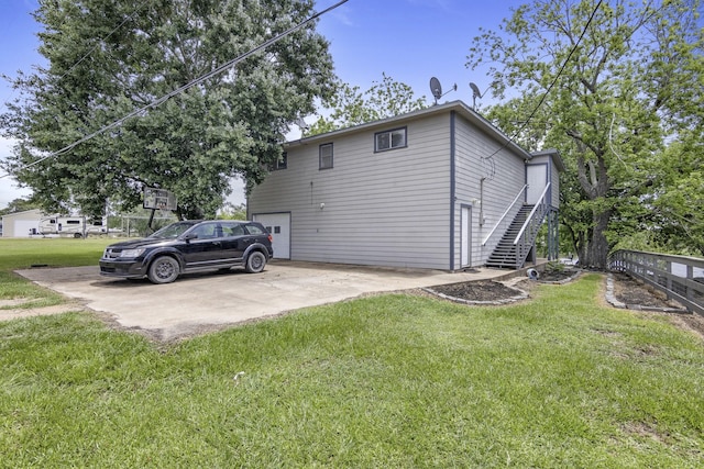 309 Kings Hl, Palacios, TX 77465 - view of home's exterior featuring a lawn, stairs, and an attached garage