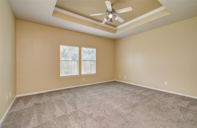 17607 Memorial Falls Dr, Tomball, TX 77375 - spare room with a tray ceiling, ornamental molding, carpet, ceiling fan, and baseboards