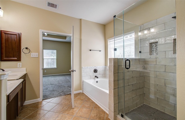 17607 Memorial Falls Dr, Tomball, TX 77375 - bathroom with tile patterned flooring, vanity, a stall shower, a garden tub, and baseboards