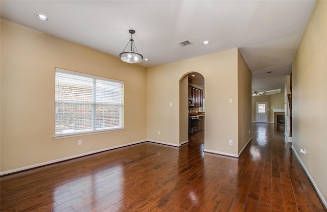 17607 Memorial Falls Dr, Tomball, TX 77375 - empty room with arched walkways, hardwood / wood-style flooring, a ceiling fan, recessed lighting, and baseboards