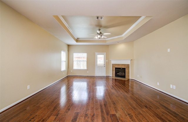 17607 Memorial Falls Dr, Tomball, TX 77375 - unfurnished living room with a raised ceiling, ceiling fan, dark wood-type flooring, ornamental molding, and baseboards