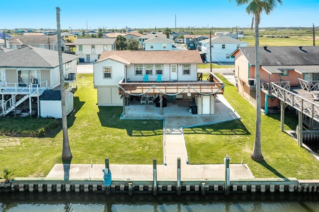 107 Crows Nest Rd, Freeport, TX 77541 - rear view of house featuring a residential view, a deck with water view, a patio area, and a lawn