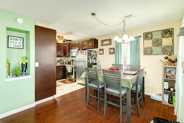 107 Crows Nest Rd, Freeport, TX 77541 - dining area with a chandelier, hardwood / wood-style flooring, baseboards, and ceiling fan