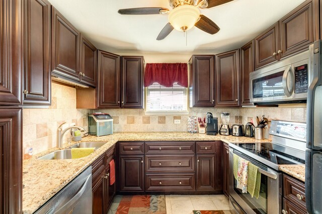 107 Crows Nest Rd, Freeport, TX 77541 - kitchen featuring appliances with stainless steel finishes, a sink, backsplash, and ceiling fan