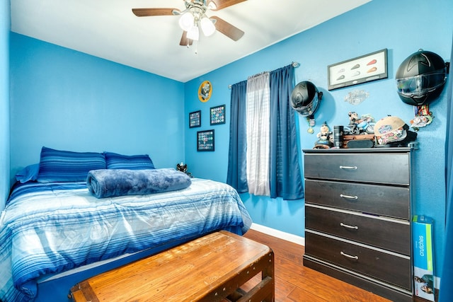 107 Crows Nest Rd, Freeport, TX 77541 - bedroom with wood finished floors, baseboards, and ceiling fan
