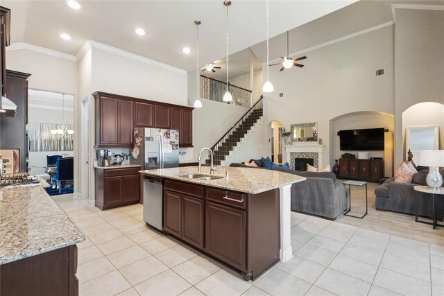 9612 Eden Ridge Ln, Pearland, TX 77584 - kitchen with a sink, appliances with stainless steel finishes, a towering ceiling, light tile patterned flooring, and a ceiling fan