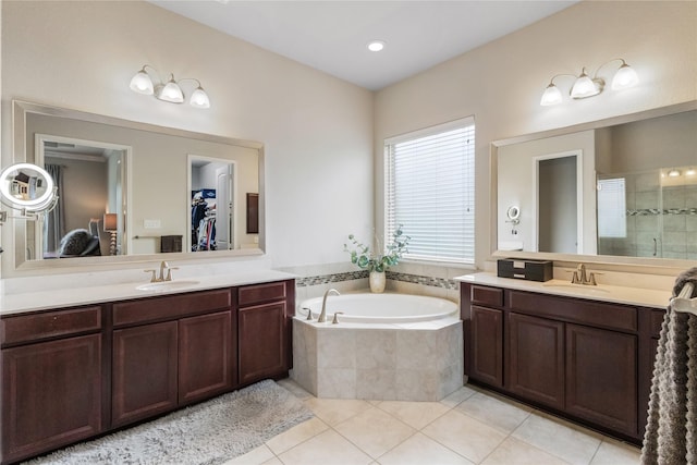 9612 Eden Ridge Ln, Pearland, TX 77584 - bathroom featuring a garden tub, two vanities, tile patterned floors, a stall shower, and a walk in closet