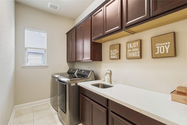 9612 Eden Ridge Ln, Pearland, TX 77584 - laundry area with cabinet space, washer and clothes dryer, baseboards, and light tile patterned floors