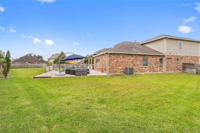 9612 Eden Ridge Ln, Pearland, TX 77584 - rear view of house with a patio, brick siding, a shingled roof, and central AC